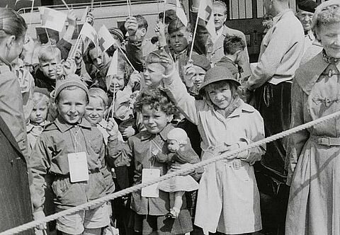 Kinder und eine Betreuerin vom DRK auf dem Flughafen Berlin-Tempelhof vor dem Abflug